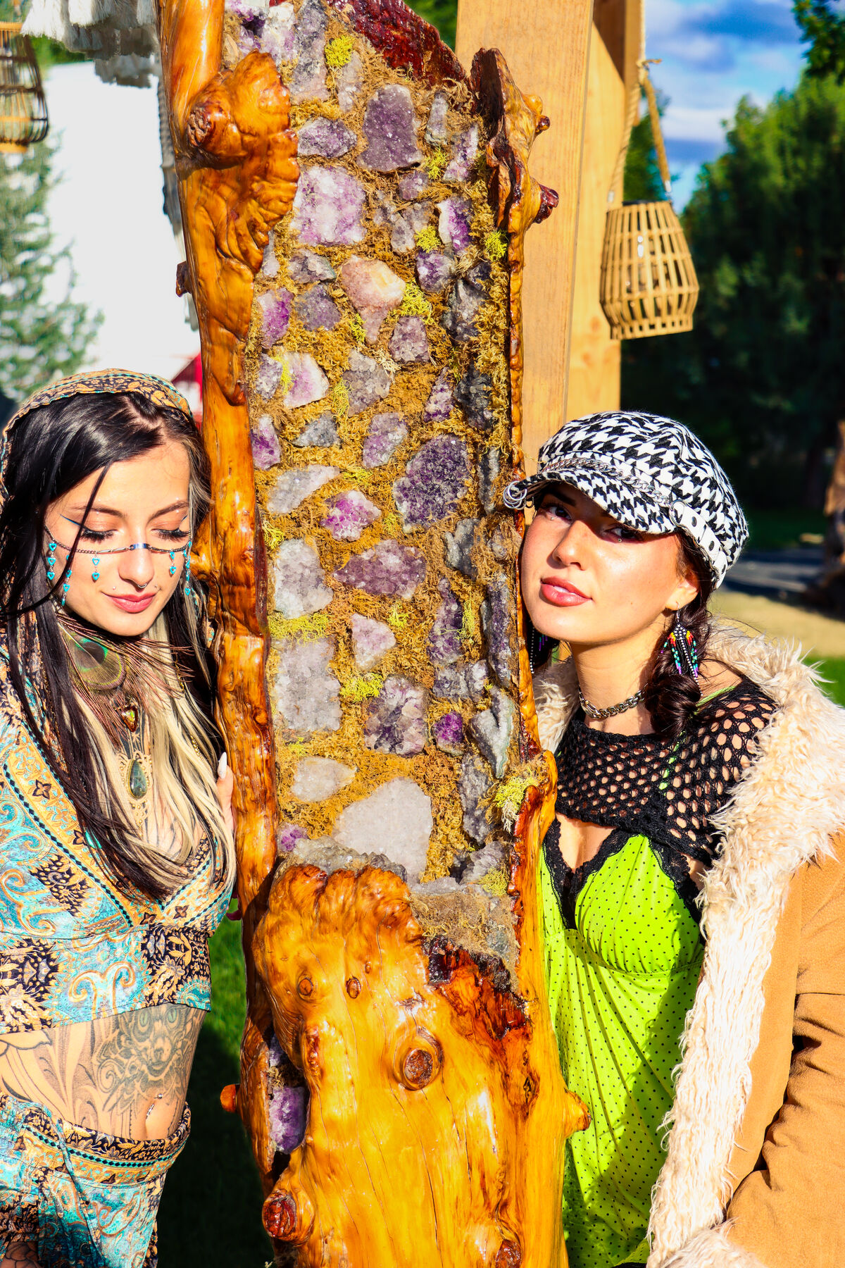 Two friends posing either side of a crystal covered pillar